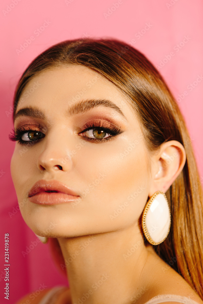 Fototapeta premium Stylish retro portrait of a beautiful girl with make-up, accessories and big eyes and lips