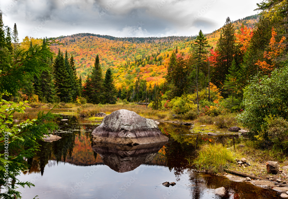 Fall colors of Lac Legault with Mont Kaaikop in the background, in cottage country in the Laurentians, Quebec, Canada.
