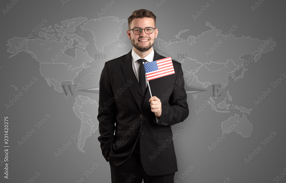 Cheerful businessman standing in front of a map with flag on his hand
Cheerful businessman standing in front of a map with flag on his hand