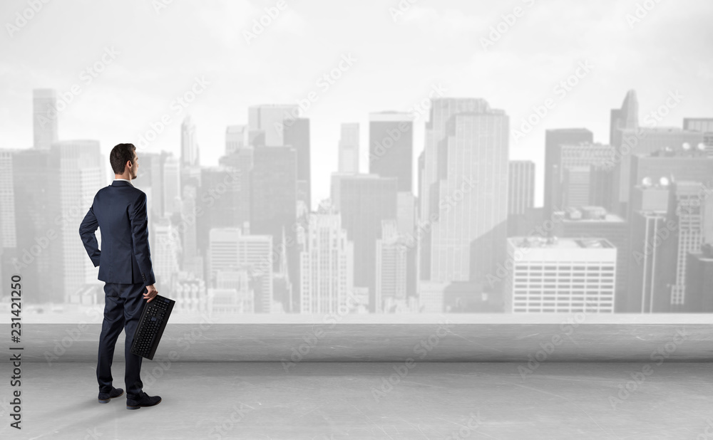 Businessman standing with his back on a roof with objects in his hand
Businessman standing with his back on a roof with objects in his hand