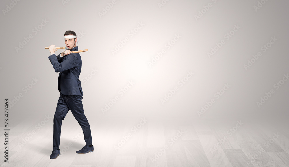 Young businessman in suit fighting in an empty space
Young businessman in suit fighting in an empty space