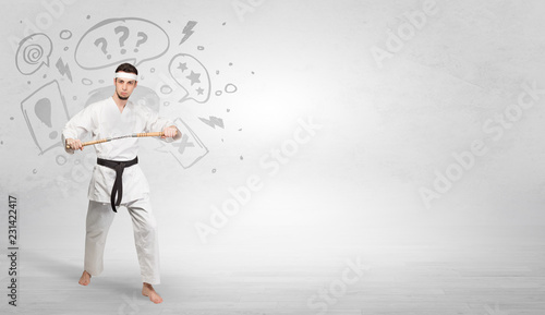 Young kung-fu trainer fighting with doodled symbols concept  