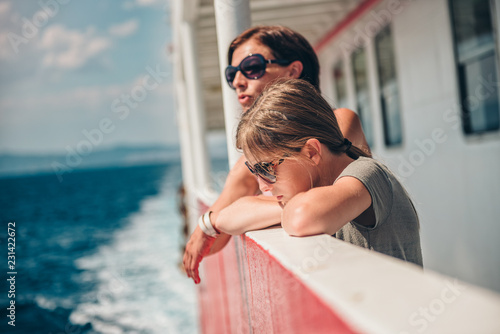 Mother and daughter traveling on a ferry boat