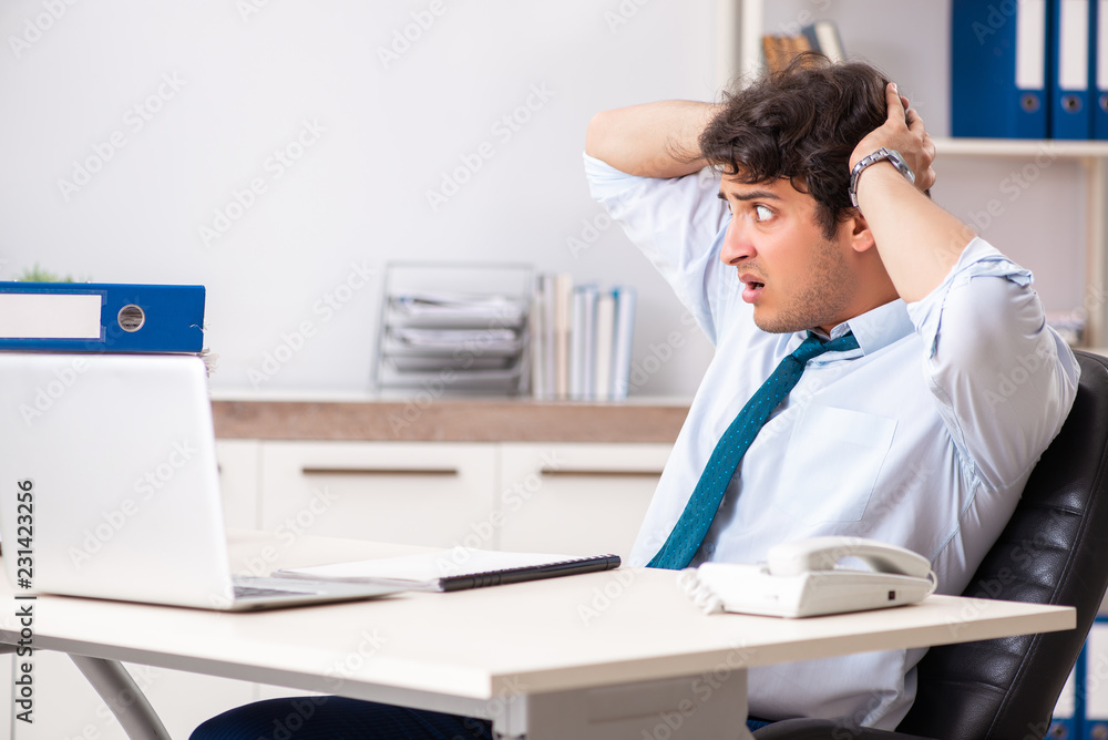 Overloaded busy employee with too much work and paperwork Overloaded busy employee with too much work and paperwork
