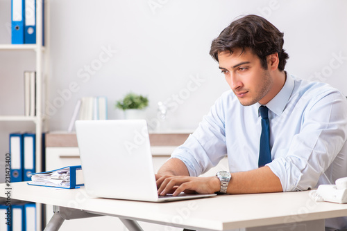 Young handsome businessman working in office