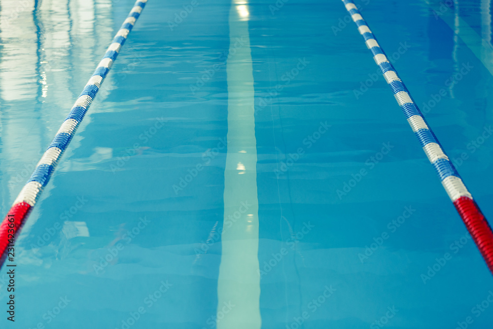 Photo from top of swimming pool with blue and white, red dividers