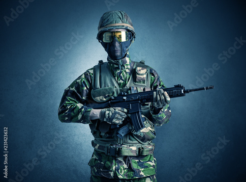 Soldier agent in a dark room with arms on his hand and gas mask  