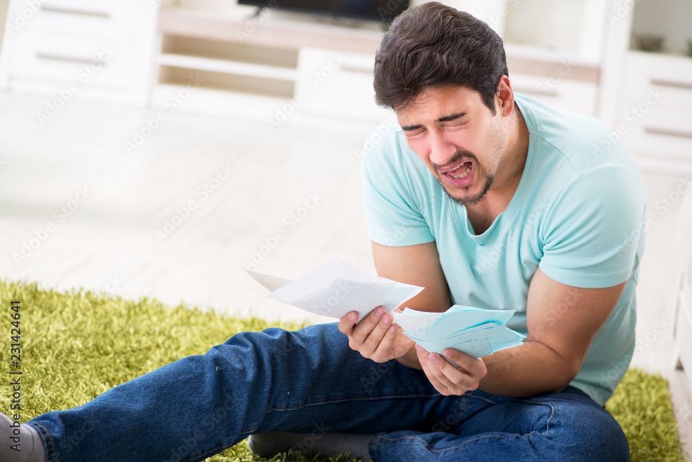 Young man struggling with personal finance and bills Young man struggling with personal finance and bills