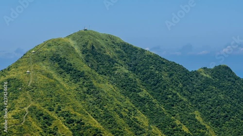 Timelapse of Keelung mountain with blue sky in New Taipei city. Beauty Hyperlapse of landscape of green mountains with long stairs and chinese pavilion. Scenic of a beautiful summer day in Jishan-Dan photo