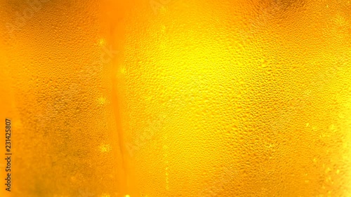 UHD macro of the glass of beer as a background