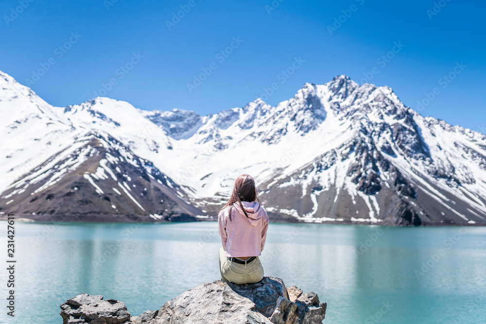 Girl looking at the amazing mountain views of the turquoise waters from the 