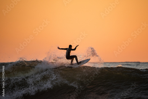 Surfer surfing on top of wave