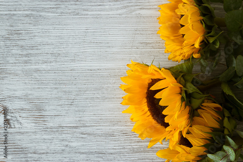 Fototapeta Naklejka Na Ścianę i Meble -  Sunflowers on wooden backgroundSunflowers on wooden background