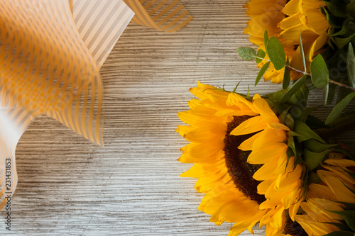 Fototapeta Naklejka Na Ścianę i Meble -  Sunflowers on wooden backgroundSunflowers on wooden background