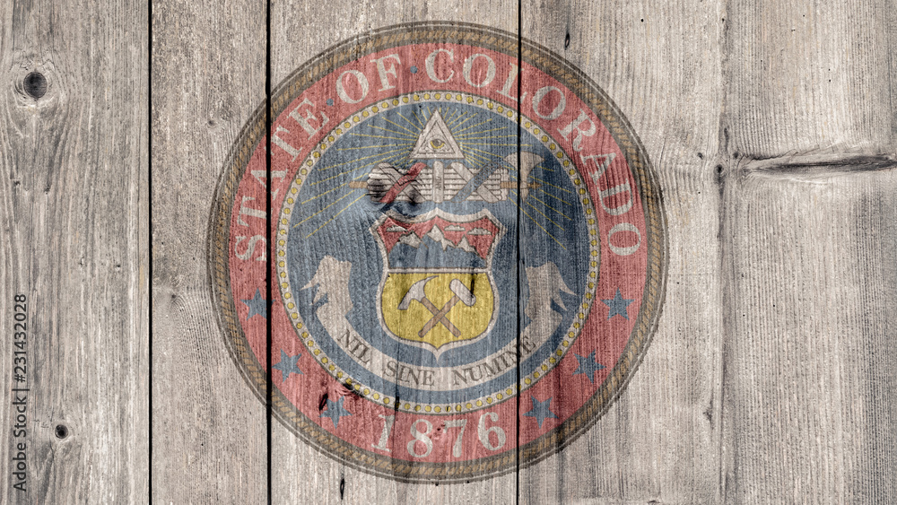 USA Politics News Concept: US State Colorado Seal Wooden Fence Background