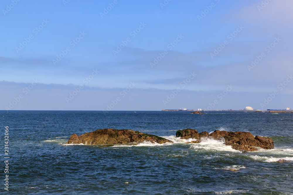Rocks in the Atlantic ocean, Porto, Portugal. Beautiful coast on a Sunny day.
