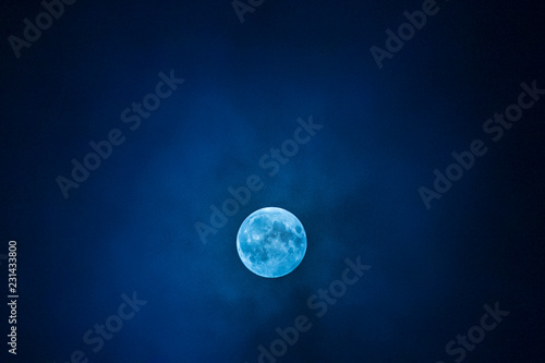 full blue moon in the dark blue sky