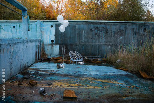 Abandoed swimming pool falling apart photo