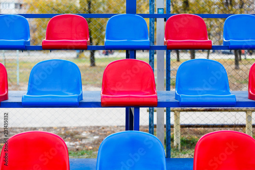 Wallpaper Mural Tribune of fans at the stadium. Empty  blue and red plastic  colored stadium seats. Abstract and Sport concept  Torontodigital.ca