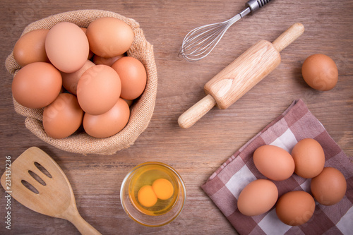 Close Up, Fresh farm eggs on a wooden rustic background, Whipping eggs and whisk,top view