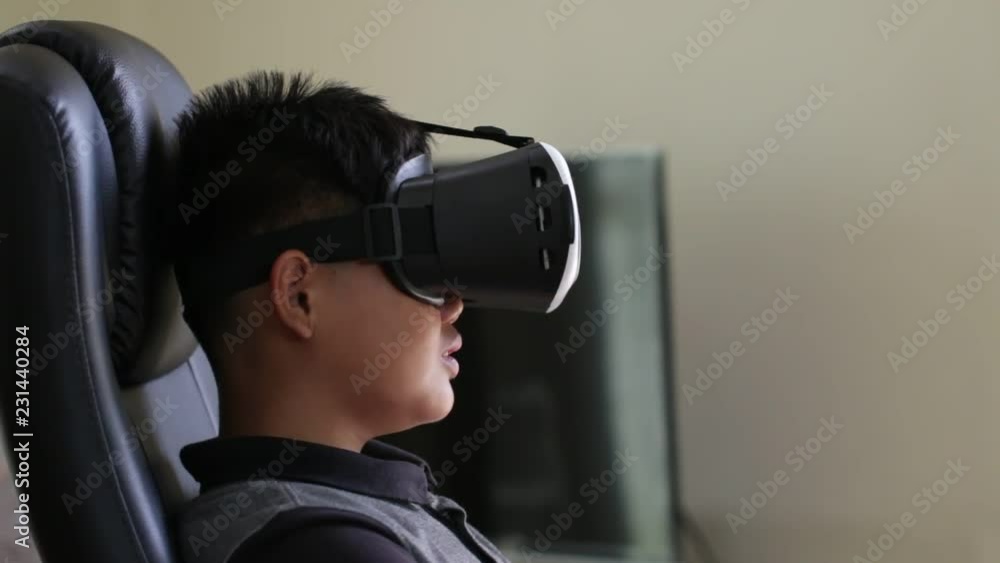 Young boy wearing virtual reality headset on digital screen. Vr is interactive computer-generated experience taking place within simulated environment. Visual future technology concept. Young boy wearing virtual reality headset on digital screen. Vr is interactive computer-generated experience taking place within simulated environment. Visual future technology concept.