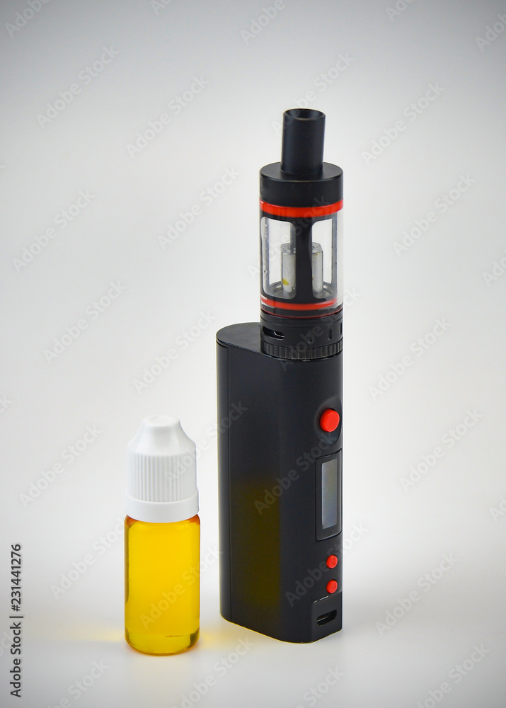 E - cigarette for vaping , technical devices.The liquid in the bottle E - cigarette for vaping , technical devices.The liquid in the bottle
