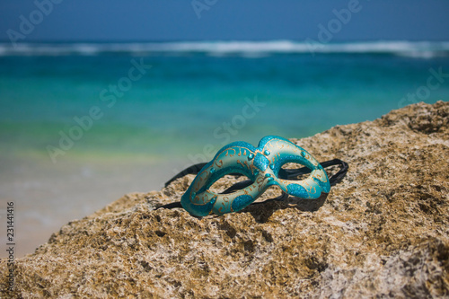 masquerade party mask on beach view