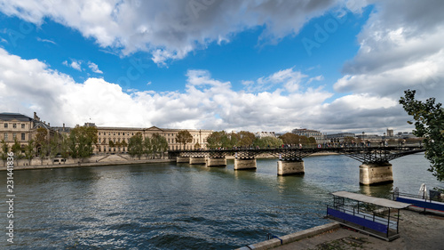 The pedestrian "Pont des arts" bridge leads to the Louvre palace where lovers around the world used to celebrate their love hooking a lock on it and through the key away