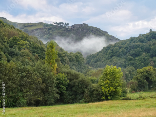 Clouds rise from the valley after a steady autumn rain - Triacastela, Galicia, Spain photo