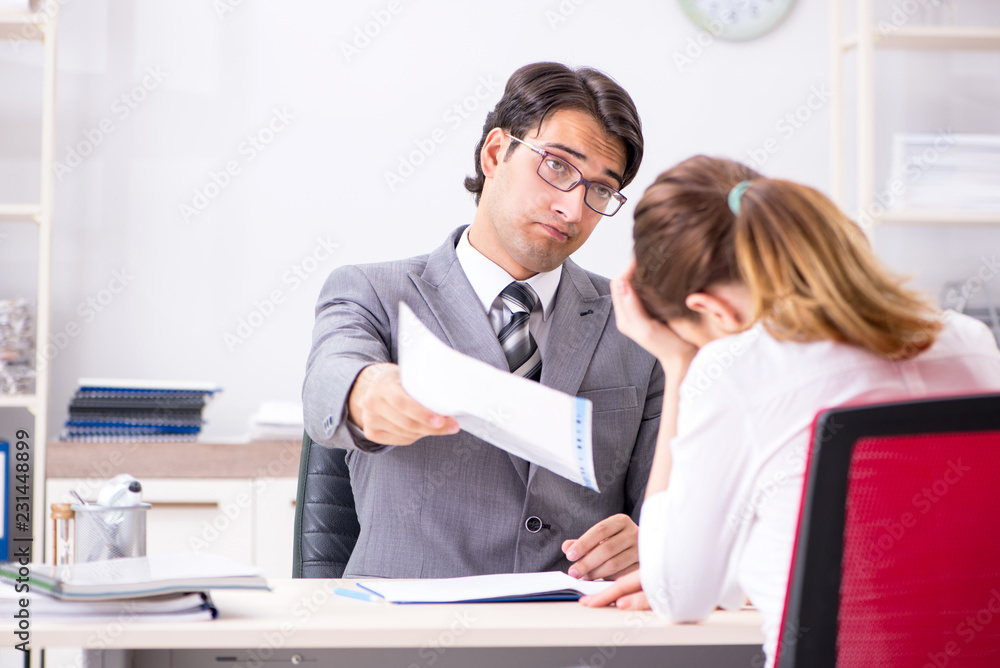 Man and woman discussing in office Man and woman discussing in office