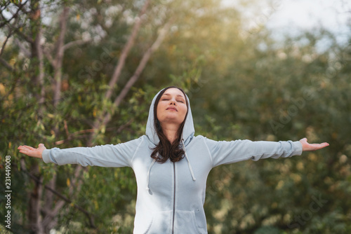 Woman standing stretch her arms relax and enjoy with nature fresh air