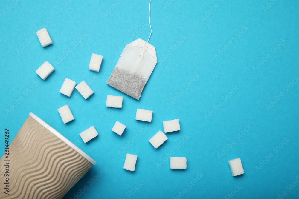 Cube white sugar and tea bag, sweetener energy drink. Cube white sugar and tea bag, sweetener energy drink.