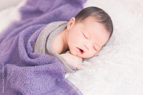 New born baby lying on a soft blanket. Cute  new born baby in natural motion.