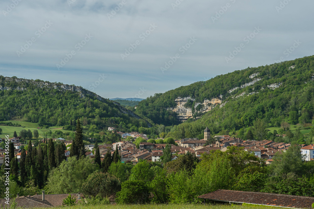 View towards ancient town in Ariege, France, with blue sky and mountains in background View towards ancient town in Ariege, France, with blue sky and mountains in background