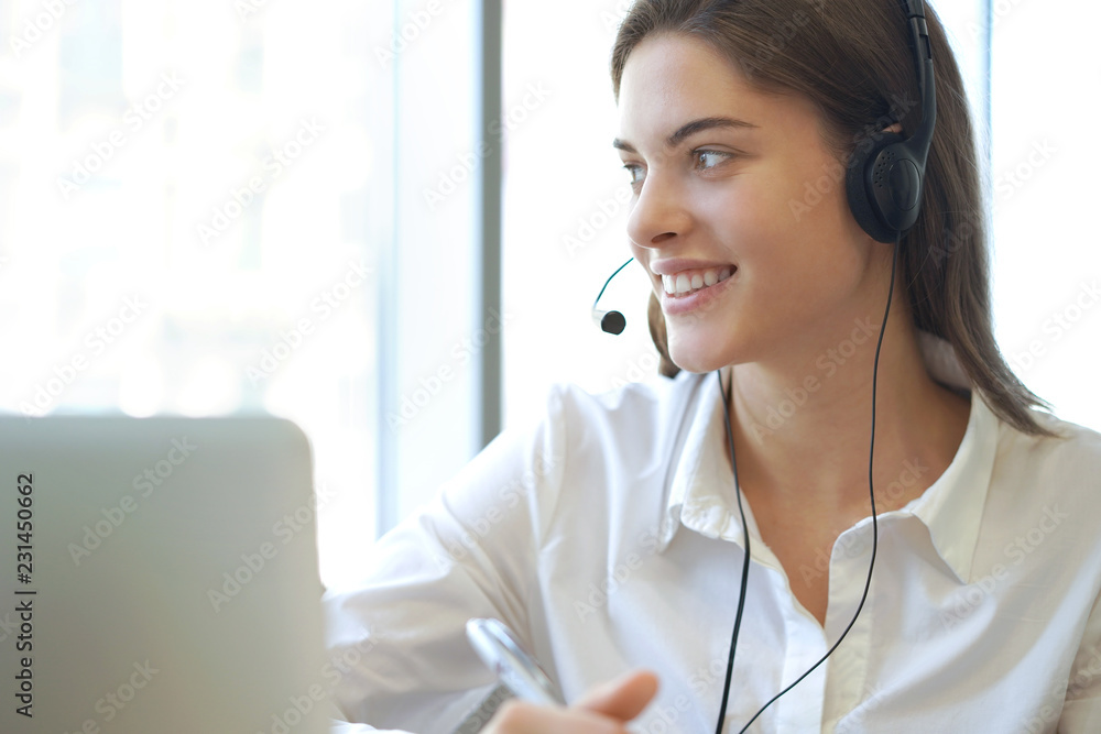 Customer support operator working in a call center office.