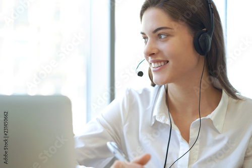 Customer support operator working in a call center office.