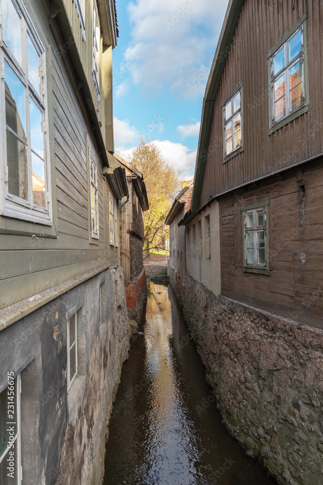 Small river between buildings in Kuldiga city, Latvia. Small river between buildings in Kuldiga city, Latvia.