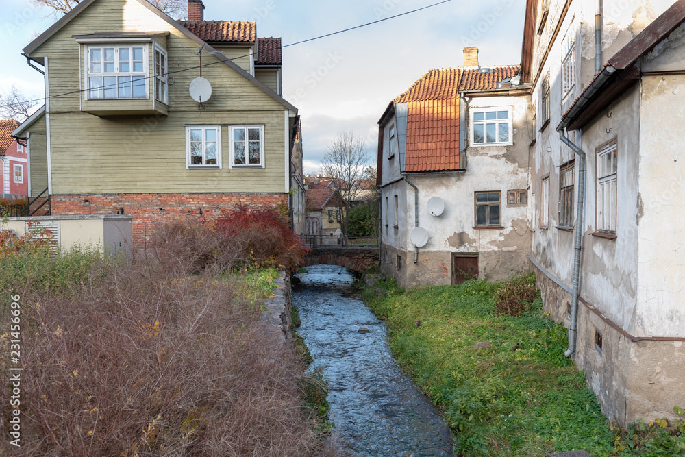 Small river between buildings in Kuldiga city, Latvia.