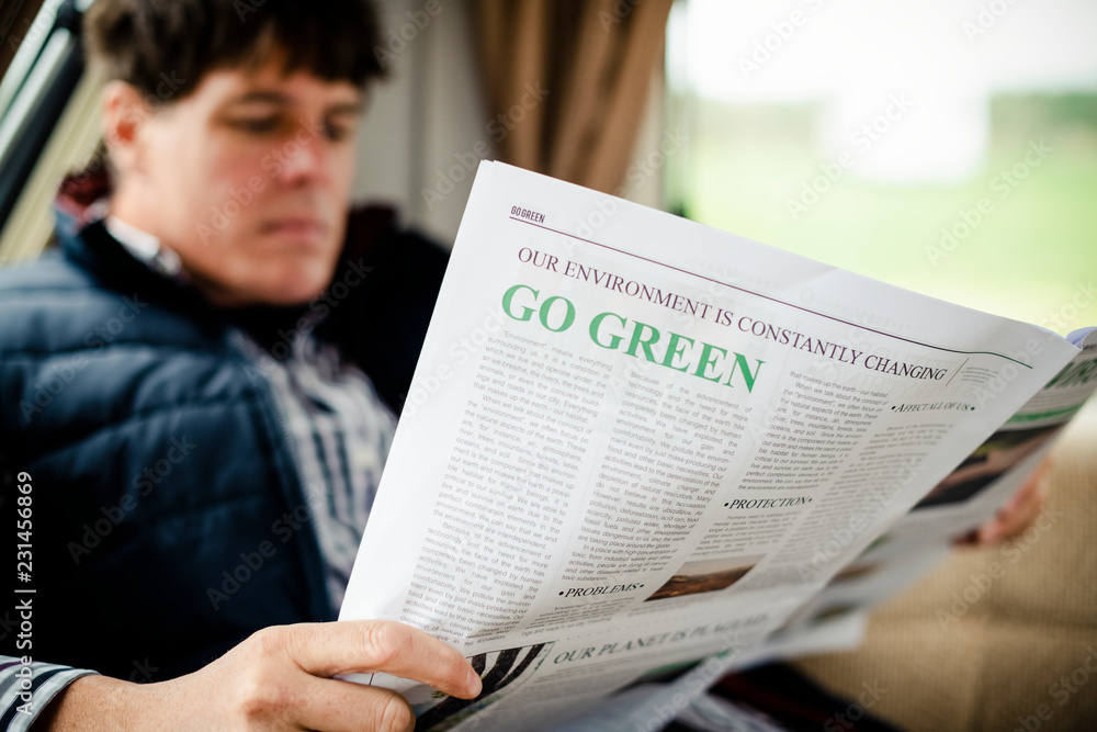 Fototapeta premium Man reading a newspaper at home