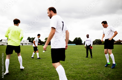 Male football players on a football pitch © Rawpixel.com