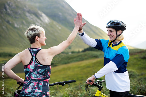 Cyclists giving each other a high five