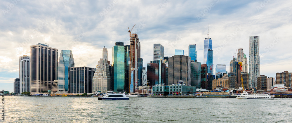 Fototapeta premium Manhattan panoramic skyline. New York City, USA. Office buildings and skyscrapers at Lower Manhattan (Downtown Manhattan)..