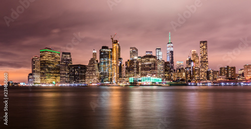 Manhattan panoramic skyline at night. New York City, USA. Office buildings and skyscrapers at Lower Manhattan (Downtown Manhattan)..