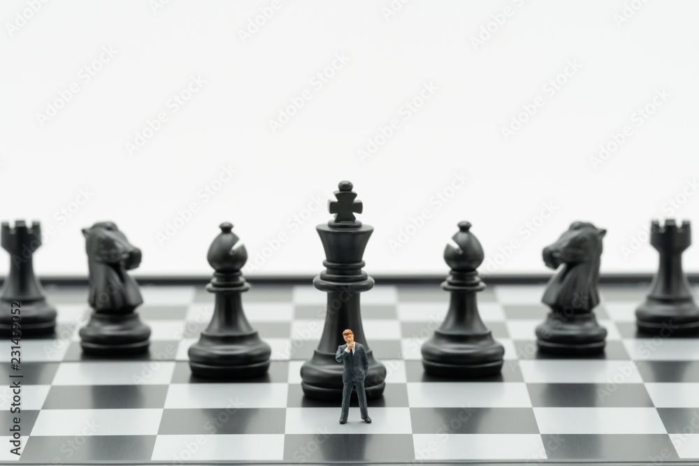 Miniature people businessmen standing Chess Analysis Communicate about business strategy. Or business planning using as background business concept and Strategy concept with copy space for your text. Miniature people businessmen standing Chess Analysis Communicate about business strategy. Or business planning using as background business concept and Strategy concept with copy space for your text.