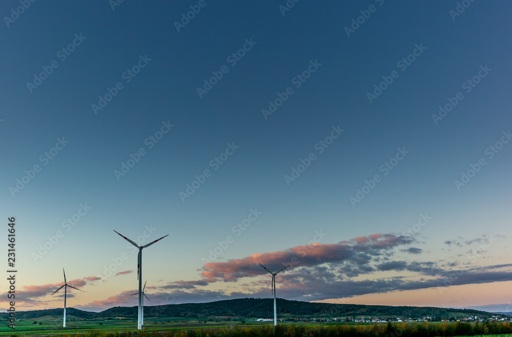 Obraz premium A wind farm in Austria at sunset in Autumn - 1