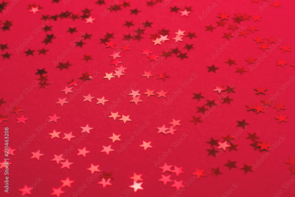 Beautiful festive red background with metallic star shaped confetti. Christmas decoration concept. Beautiful festive red background with metallic star shaped confetti. Christmas decoration concept.