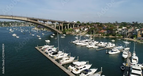 Parramatta river between Gladesville and Drummoyne connected by Gladesville bridge in Sydney Inner West with distant city CBD towers.
 photo