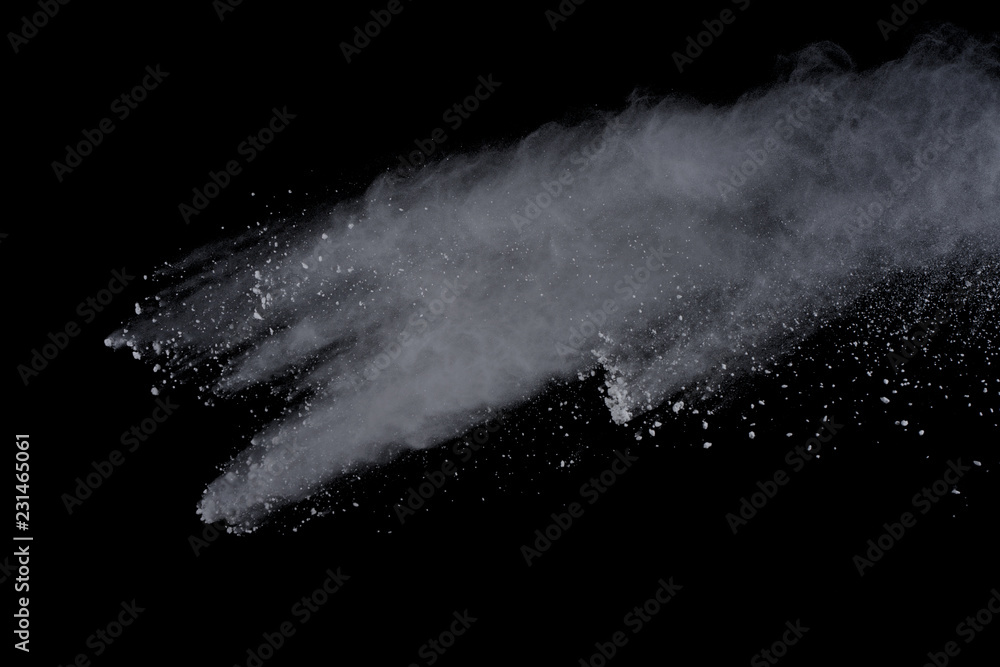 White powder explosion on black background. Dust splatted isolated. Paint Holi.