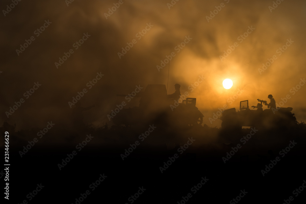 War Concept. Military silhouettes fighting scene. World War German Tanks and soldiers silhouettes at sunset. Attack scene. Armored vehicles.