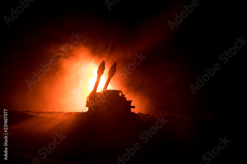 Fototapeta Naklejka Na Ścianę i Meble -  Rocket launch with fire clouds. Battle scene with rocket Missiles with Warhead Aimed at Gloomy Sky at night. Rocket vehicle on War Backgound